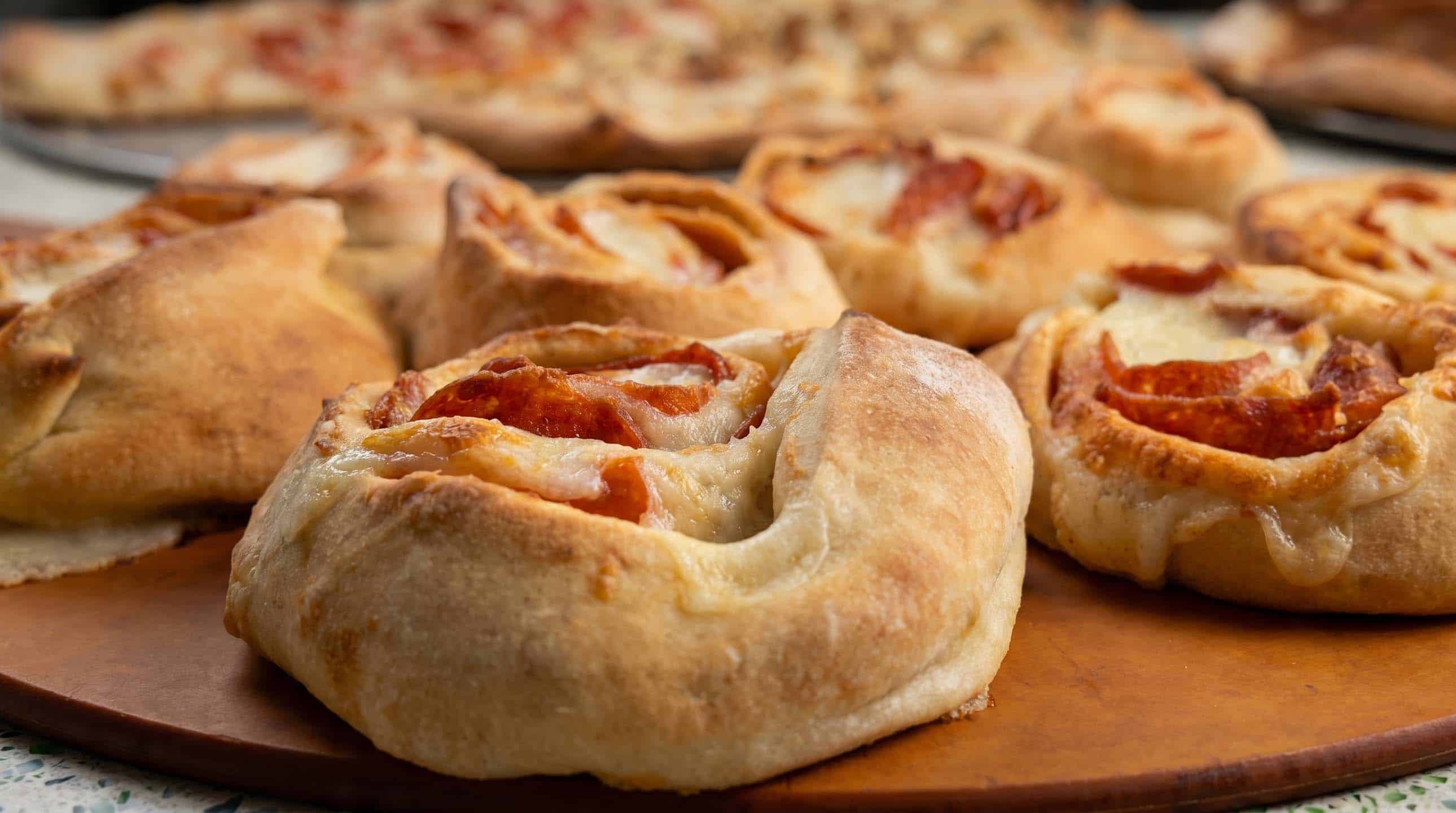 Freshly baked pepperoni rolls on a wooden board